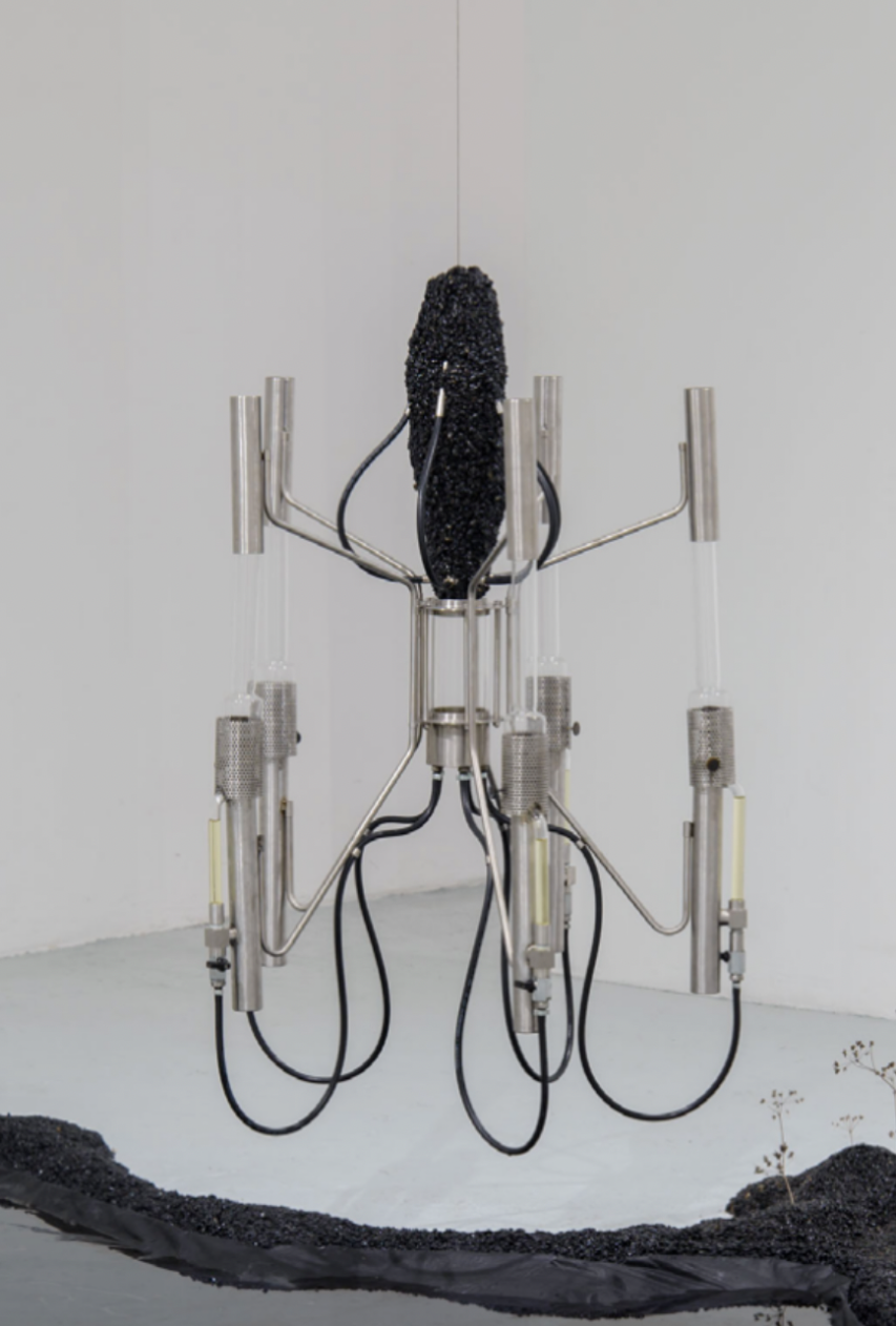 Valentin Vert, *Naphtex Kerogen (ou les remords de Prométhée)*, 2024, bitume, acier inoxydable, bec d’argand, kérosène, eau, 150 x 80 x 80 cm. Courtesy the artist.